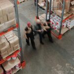 Blurred motion of workers managing inventory in a warehouse.